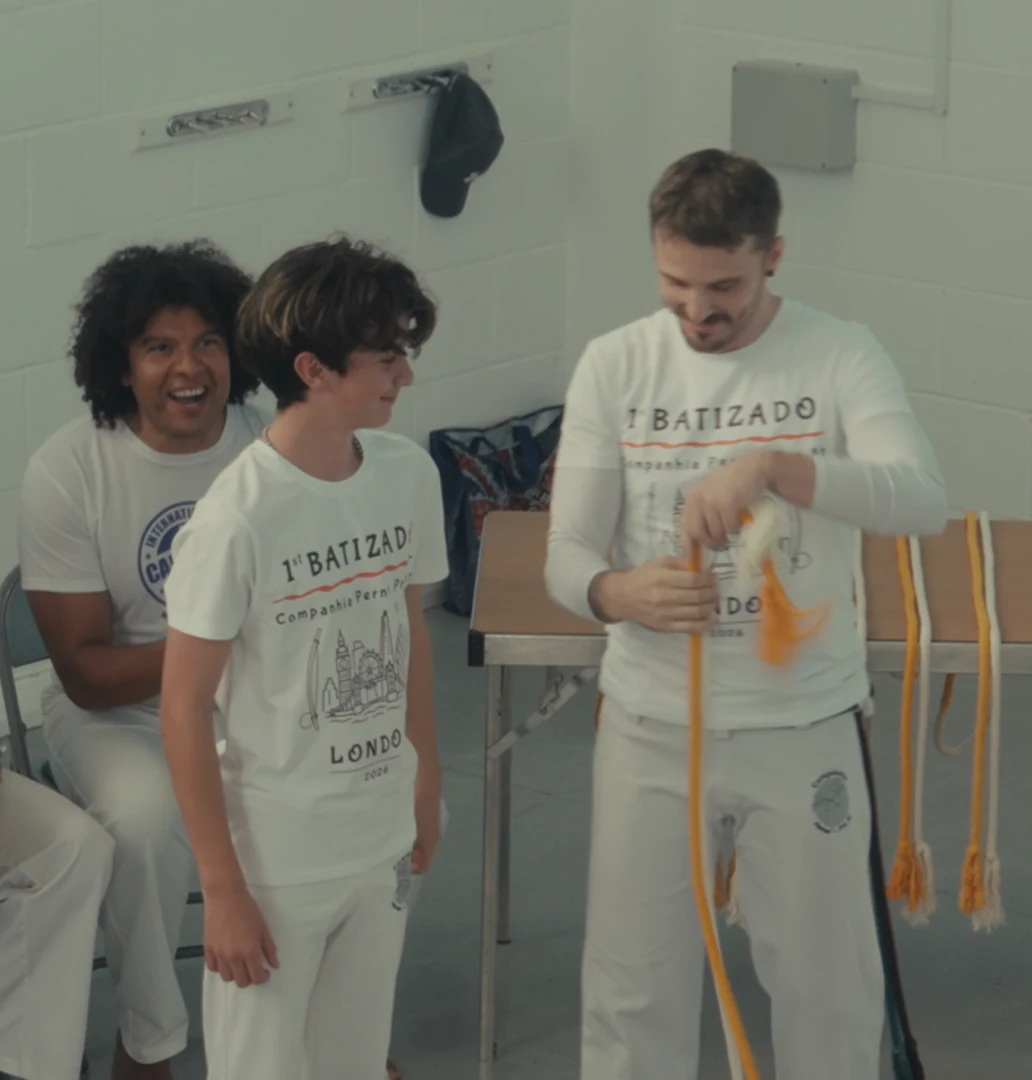 A student receiving a yellow cord at the batizado