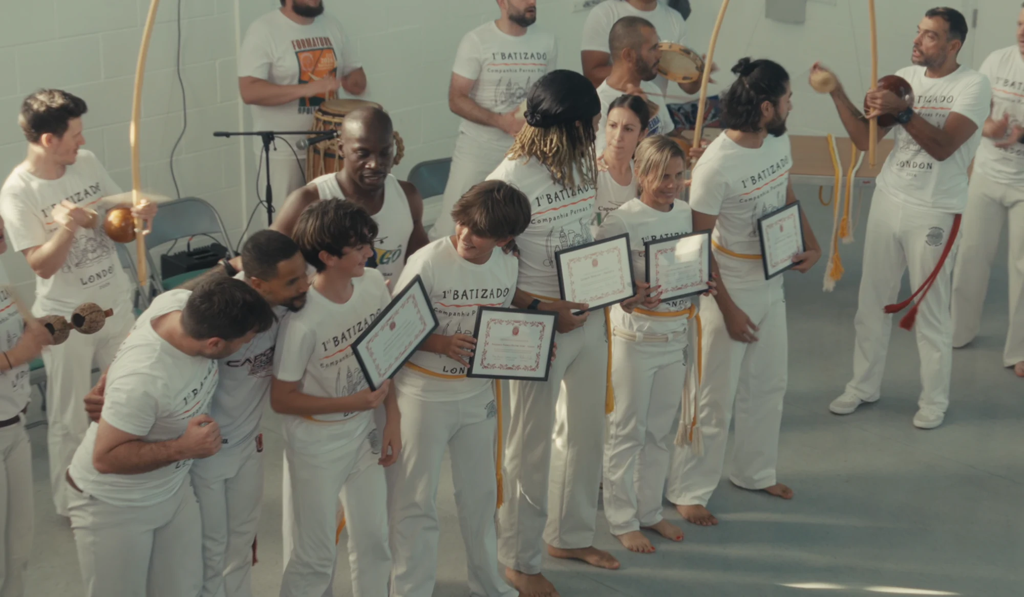 Students celebrating with their batizado certificates