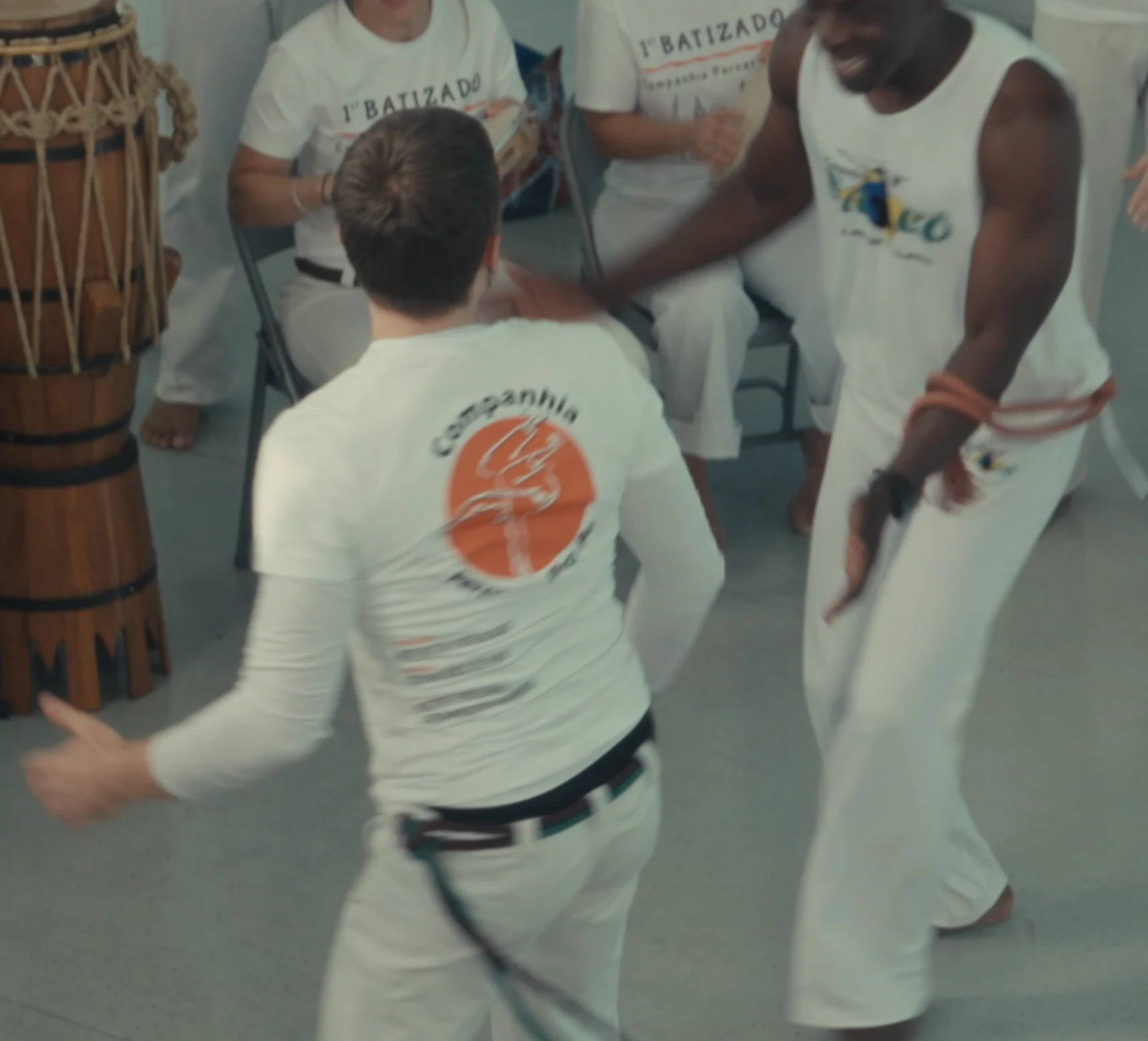 Two capoeiristas playing beside the atabaque
