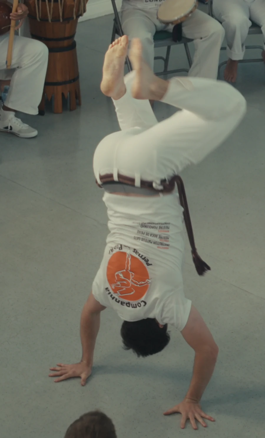 A capoeirista balancing upside down on both hands