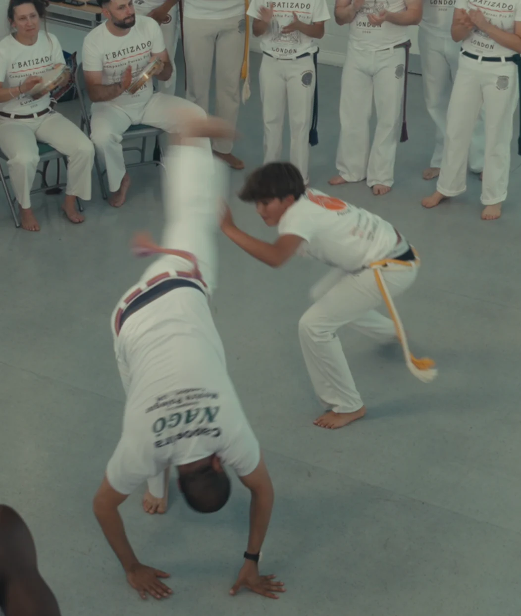 A student evading a cartwheel in front of the musicians