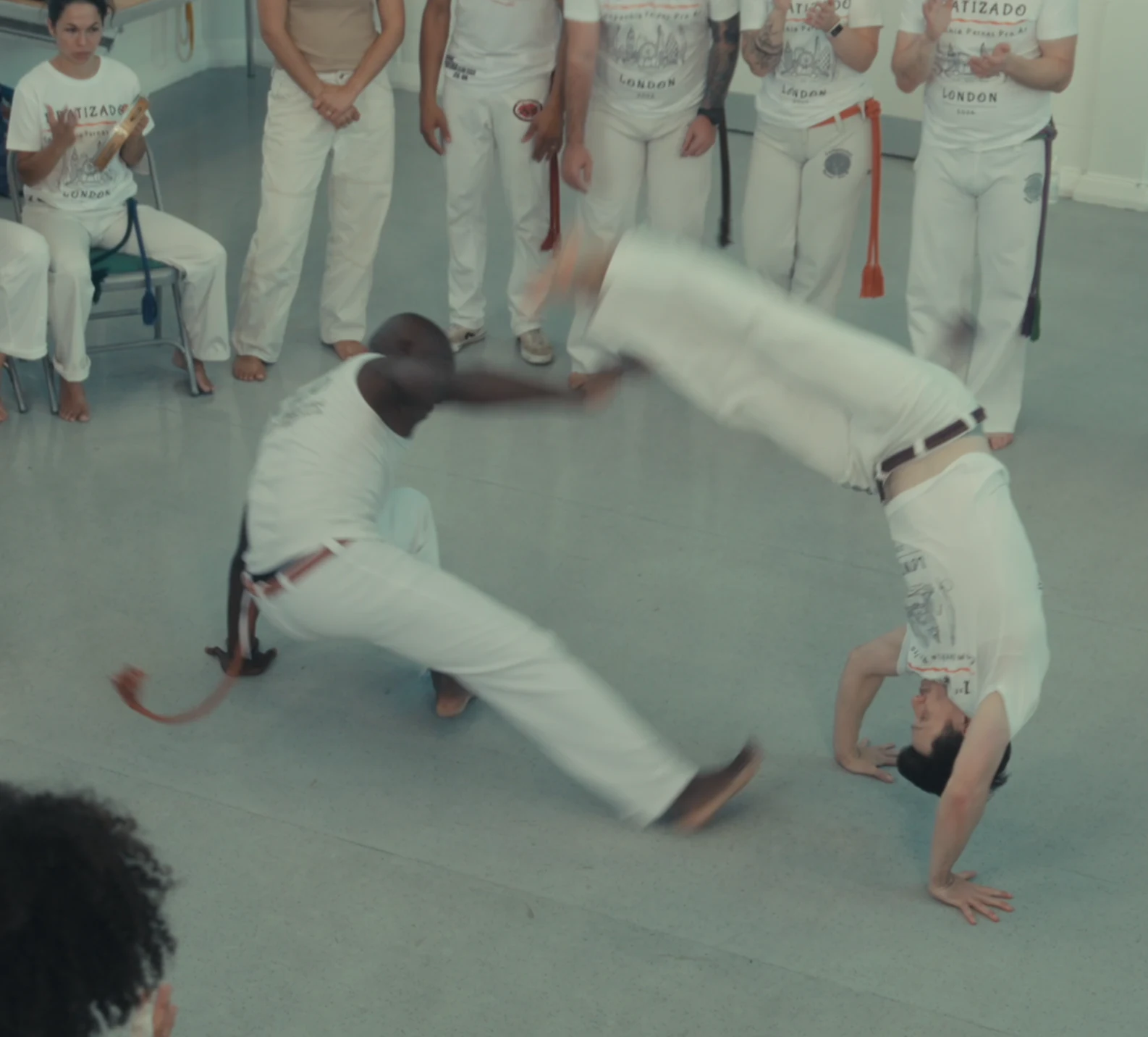 A sweeping kick beside an inverted balance
