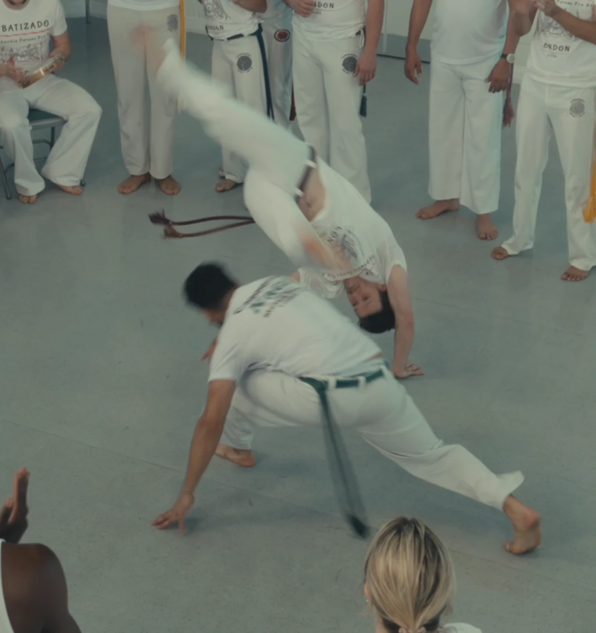 Two capoeiristas exchanging low and inverted movements