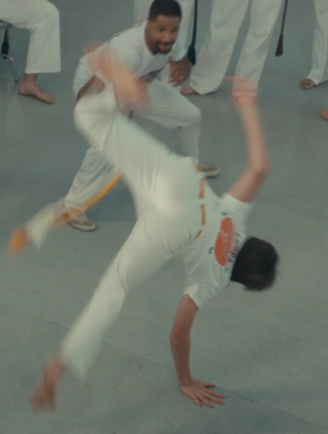 A student with a yellow cord turning on one hand