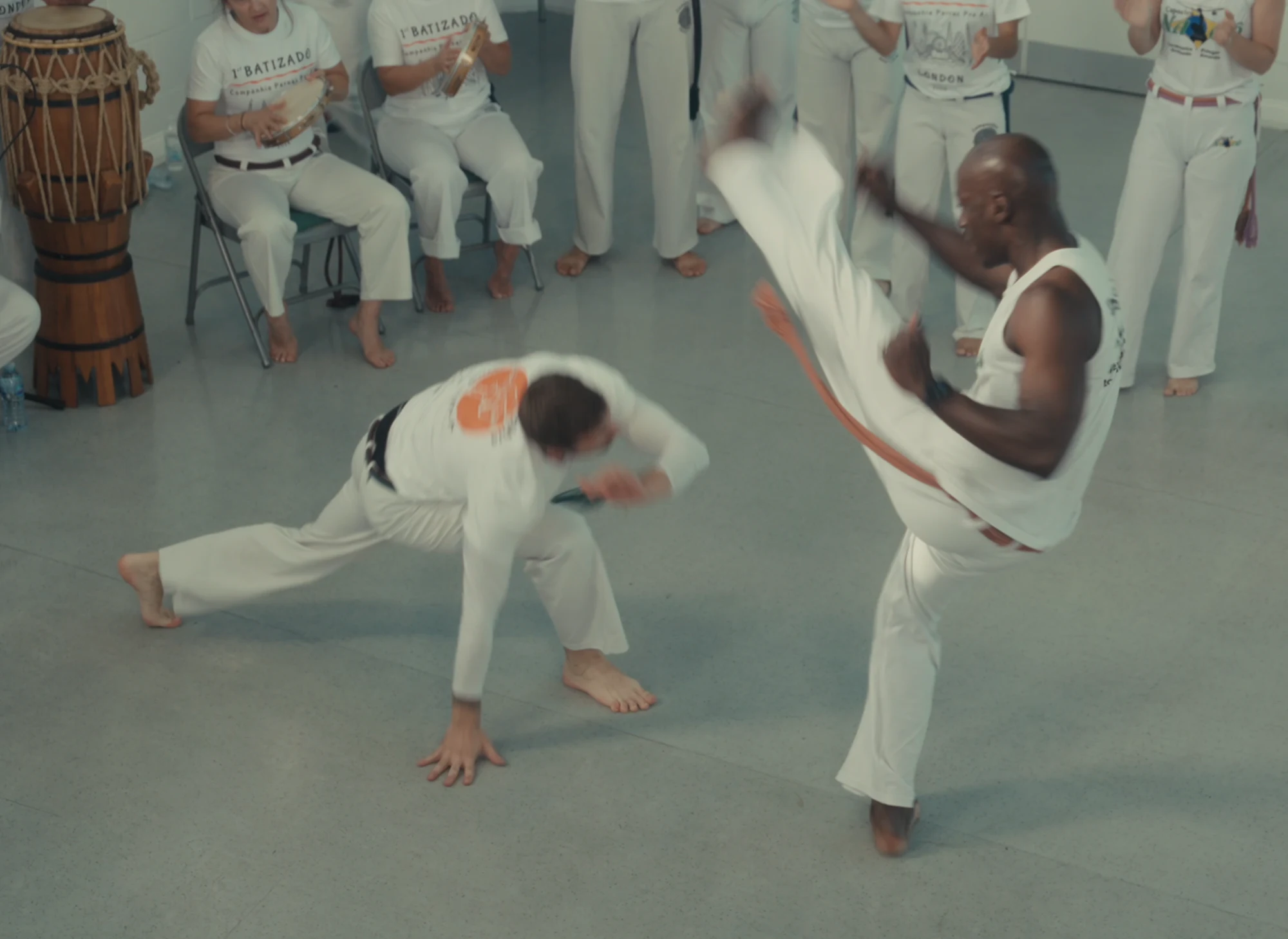 A high kick met with a low evasion beside the musicians
